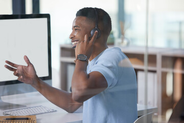 Hes about to close off on another big sale. Shot of a young businessman working in a call centre.