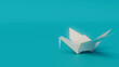 © RocknRoller Studios - White Origami Bird on Turquoise Background with Copy Space. Minimalist Design with Folded Paper Bird.