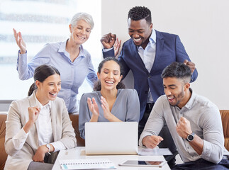 Wall Mural - Working independently toward one goal. Shot of a group of colleagues cheering in a office.