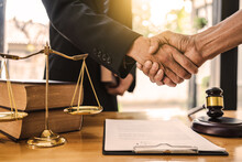 Businessman Shaking Hands To Seal A Deal With His Partner Lawyers Or Attorneys Discussing A Contract Agreement.