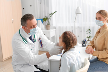 Poster - Doctor examining little girl with sore throat in clinic