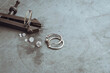 Jewelry production concept. Silver ring with gemstone on jeweler's workbench. Workplace of a jeweler. Tools and equipment for jewelry work on an metal desktop.