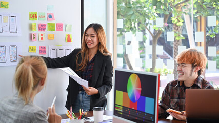 Wall Mural - website development team brainstorming and discussing about mobile app interface wireframe design at