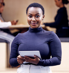 Canvas Print - Im ready to lead this business. Shot of an attractive young businesswoman standing in the office and holding a digital tablet.