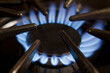 © Mint Images - Close up of gas hob with the burner lit. Power heat and energy. Blue flames