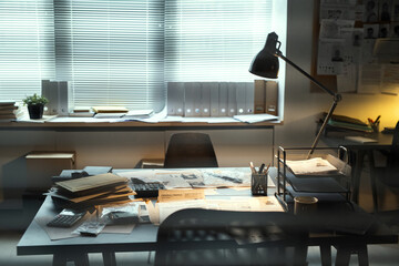 Poster - Lamp lighting workplace of contemporary FBI agent with criminal profiles, stacks of journals, documents and other supplies