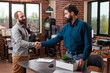 © DC Studio - Businessman greeting sad fired entrepreneur man while carrying his box with belongings after being fired. Multiracial businesspeople working at company strategy in startup office
