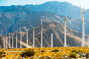 Wind turbines on sunny summer autumn mountain landsape. Green ecological power energy generation. Wind farm eco field