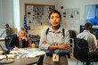 © pressmaster - Young Hispanic female leader of intelligence service or police department in uniform crossing arms on chest while standing against coworkers