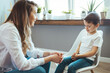 © Dragana Gordic - Cheerful young kid talking with helpful child counselor during psychotherapy session in children mental health center. Child counselor during psychotherapy session