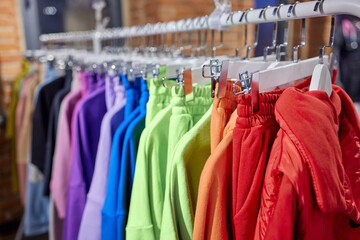 Fashion clothes on clothing rack, Bright colorful cotton shirts on hanger in boutique shop.