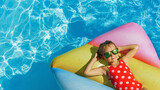 Fototapeta  - Child in swimming pool. Having fun on vacation at the hotel pool. Colorful vacation concept.