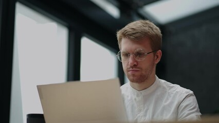 smart person is working in it-company, man is using laptop for creating software program or video game and application