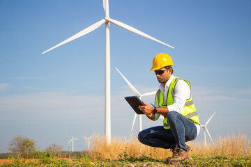 engineer team working in wind turbine farm. Renewable energy with wind generator by alternative energy concept.