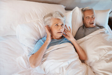 Poster - Youd have thought Id be used to his snoring. Cropped shot of a senior woman blocking her ears in frustration while her husband snores in bed beside her.