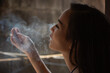 Young woman smoking cigarette, cannabis, marijuana.