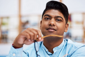 Wall Mural - Let me tell you about our brand. Portrait of a confident young businessman working in a modern office.