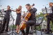 Musical ensemble playing classical music on outdoor stage