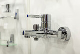 Fototapeta Łazienka - Shiny chrome faucet on the wall. Design and renovation. Close-up.