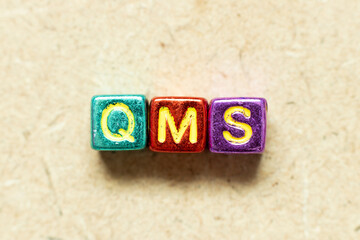 Poster - Metallic color alphabet letter block in word QMS (abbreviation of quality management system) on wood background