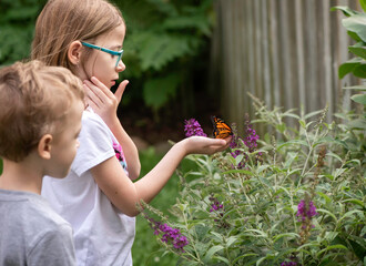 Wall Mural - child releasing monarch butterfly