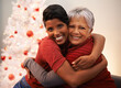 © Mapodile M/peopleimages.com - Finally home for the holidays. A senior woman receiving a hug from her daughter on Christmas.