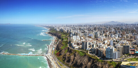 Aerial panorama of Lima, Peru along the coast also known as Circuito de Playas de la Costa Verde at a golden hour sunset