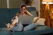 © руслан малыш - A girl with a dog watching a movie on a laptop with headphones. Pets and pet friends for people