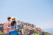 © travnikovstudio - Happy family with view of the old european village in Cinque Terre national park, Liguria, Italy