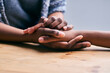 © Lerato Maleswena/peopleimages.com - Supporting a friend. Cropped shot of a two people holding hands in comfort on a table.