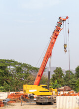 The Large Mobile Crane With The Long Boom Is Ready To Lift The Metal Frame.