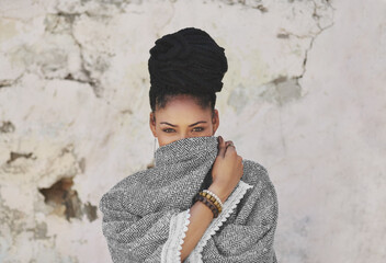 Poster - Beauty attracts the eye but personality attracts the heart. Cropped portrait of an attractive young woman covering her mouth with her poncho.