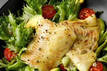 Wall Mural - Halibut Steak and Vegetables. Baked halibut fish. Healthy dinner, close up. Green salad