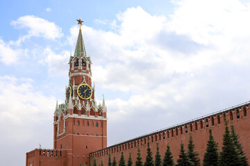 Wall Mural - Red square in Moscow with Kremlin tower, chimes and brick wall on cloudy sky background. Symbol of Russian authorities