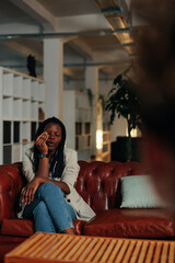 Wall Mural - Afro woman wiping tears during meeting with a psychologist