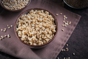 Wall Mural - Bowl of cooked peeled barley grains porridge