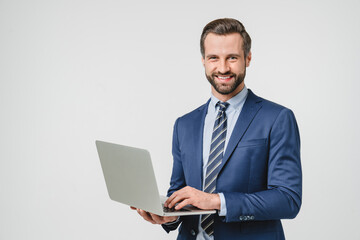 Successful young confident businessman using laptop for e-learning, remote work, watching webinar application online isolated in white background