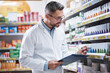 © Thurstan Hinrichsen/peopleimages.com - Medication is his specialty. Shot of a mature pharmacist doing inventory in a pharmacy.