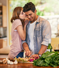 Sticker - I love it when you cook for me. Shot of a young woman kissing her husband while he prepares dinner.