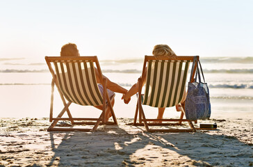 Canvas Print - Ill hold on to you forever. Shot of a couple holding hands while watching the sunset on a beach.