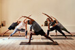 © Chanelle Malambo/peopleimages.com - Yoga lets your inner warrior loose. Shot of a group of young men and women practicing yoga in a fitness class.