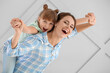 © Pixel-Shot - Portrait of happy mother and daughter on grey background