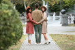 © Pixel-Shot - Man with two beautiful women walking in park. Polyamory concept