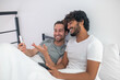 © zinkevych - Cheerful man pointing at his cellphone screen to his boyfriend