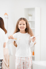 Canvas Print - Little girl with tooth brush and paste in bathroom