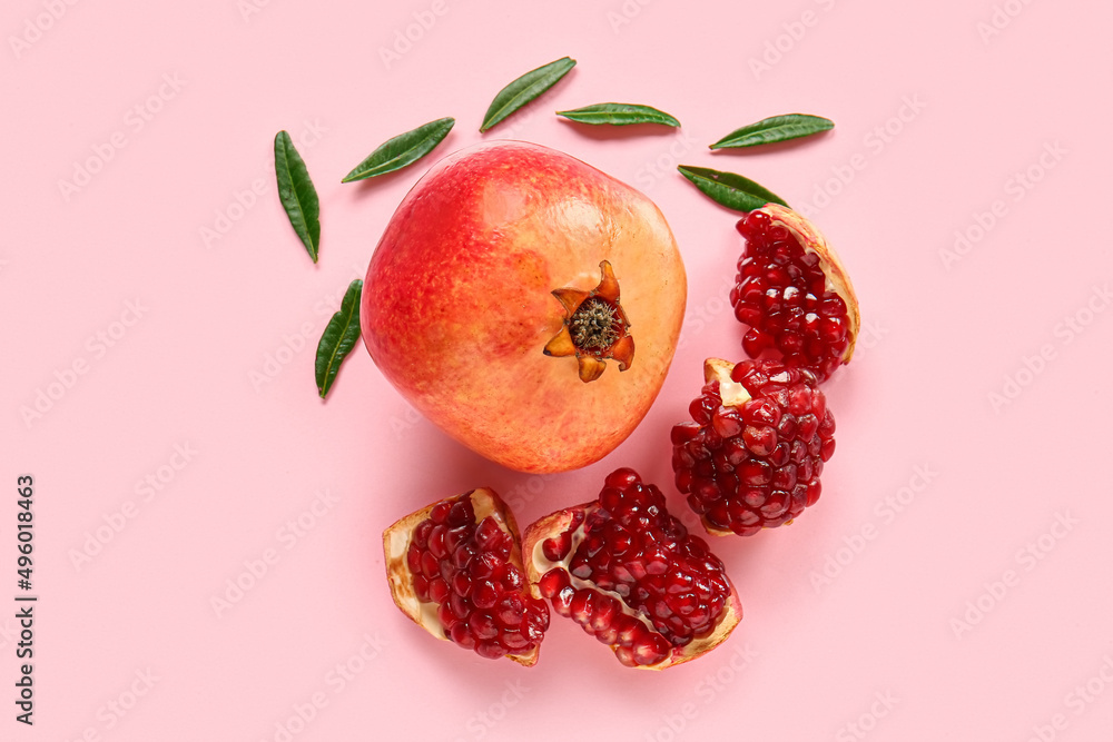Tasty ripe pomegranate pieces on pink background