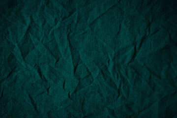 Wall Mural - Green crumpled cotton fabric. Dark wrinkled cloth. Вackground with space for design.     