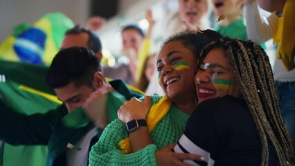 Wall Mural - Brazilian young football fans celebrating their team's victory at stadium.