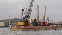 Industrial Barge Doing Maintenance Dredging In Gothenburg, Emptying Bucket With Sediments