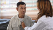 © Prathankarnpap - Doctor using stethoscope examining senior patient lungs during home visit.